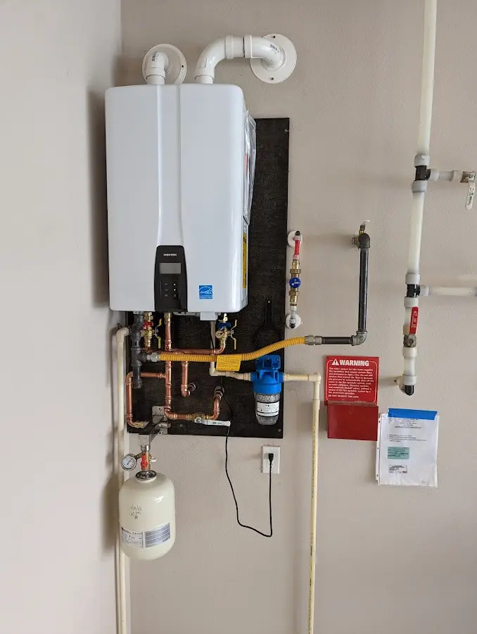 Professional plumber installing copper piping in a Delanco home